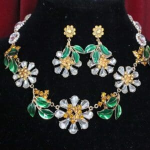A necklace and earrings set with green flowers.
