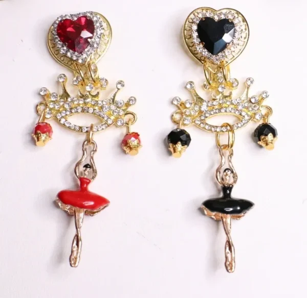 A pair of earrings with hearts, lips and keys.