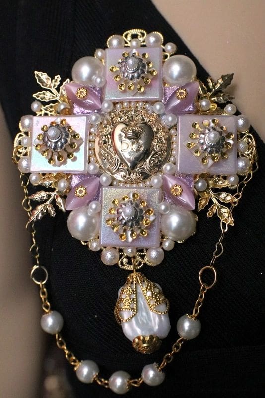 A close up of the cross on the arm of a woman.