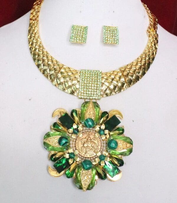 A necklace and earrings set with green stones.