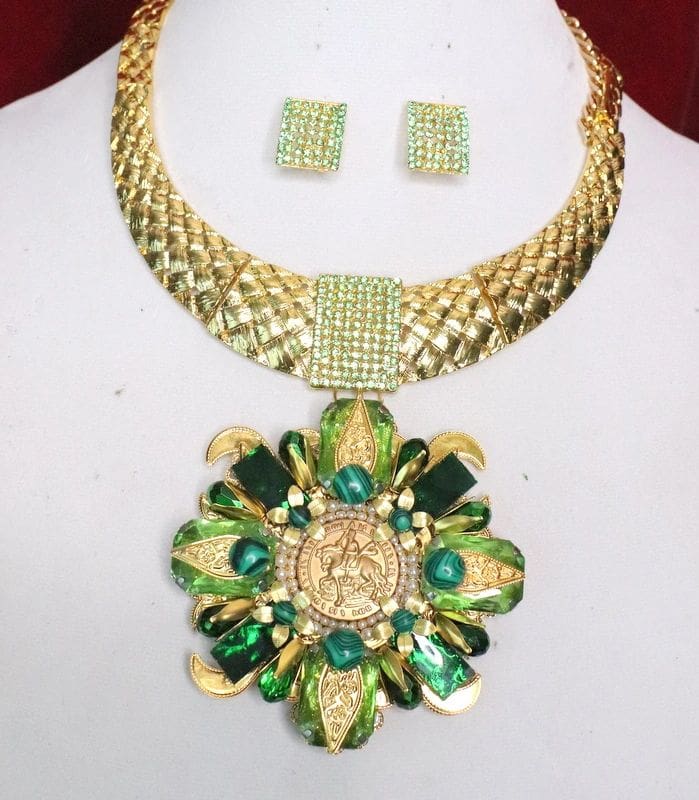 A necklace and earrings set with green stones.