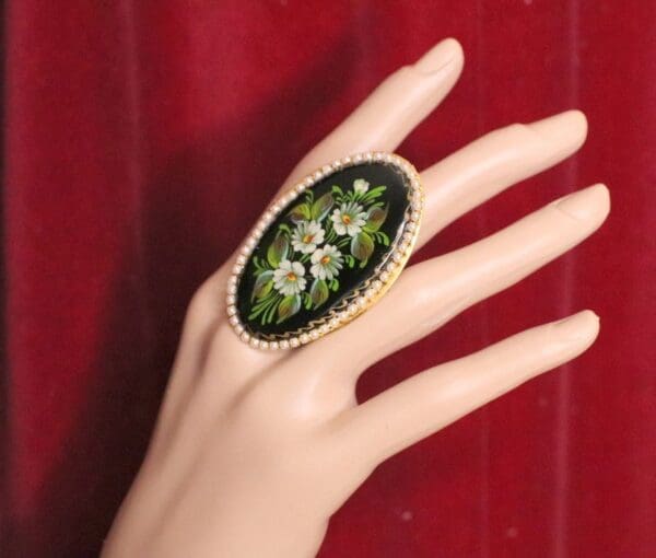 A woman 's hand with a ring on it