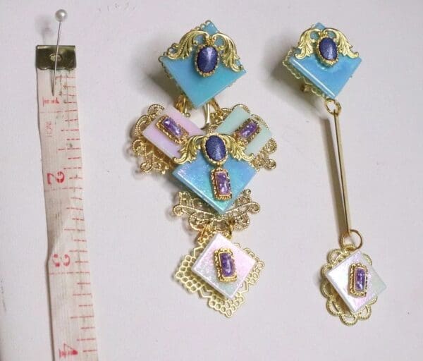 A set of three pieces of jewelry with a measuring tape.