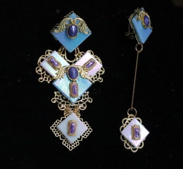 A pair of earrings with blue and white stones.