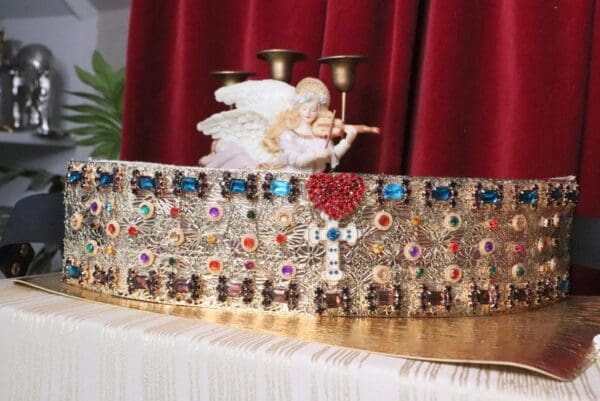 A close up of an ornate crown on a table