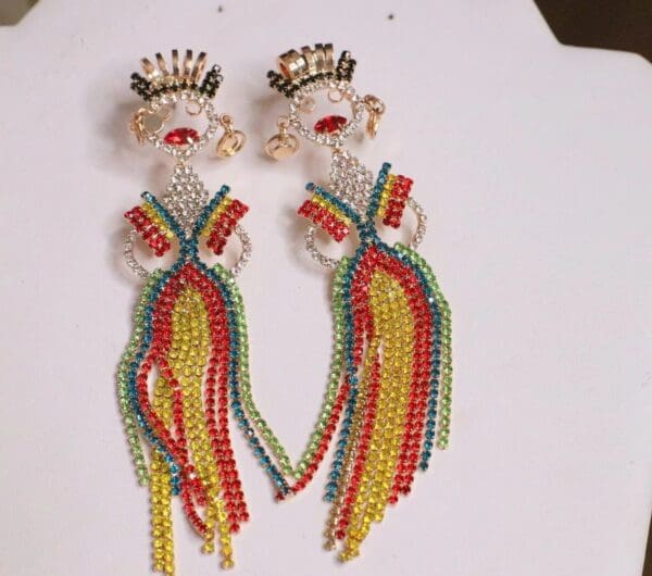 A pair of earrings with beads and chains.