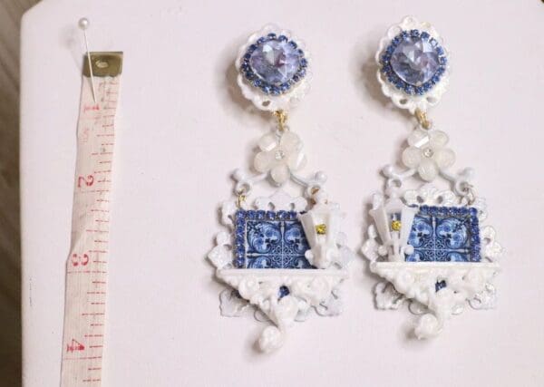 A pair of earrings hanging on the wall
