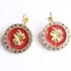 A pair of earrings with red and gold flowers.