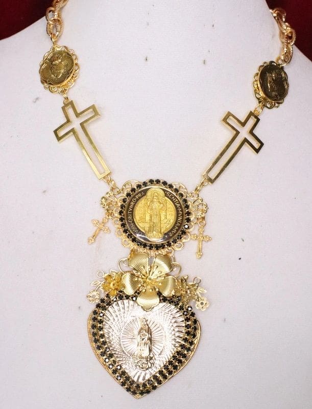 A necklace with crosses and medals on it