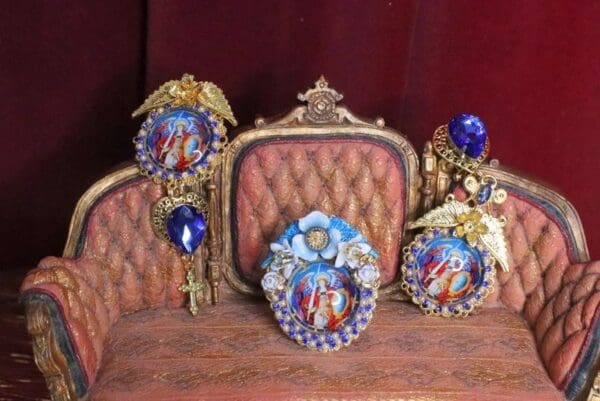 A set of four ornate frames sitting on top of a couch.