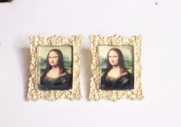 A pair of framed paintings of mona lisa.
