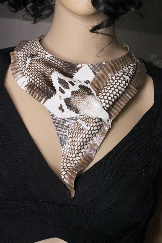 A woman wearing a brown and white scarf with a star on it.