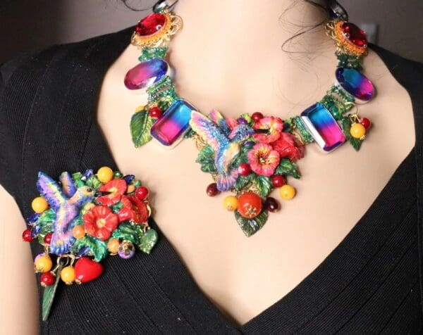A woman wearing a necklace and bracelet with colorful flowers.