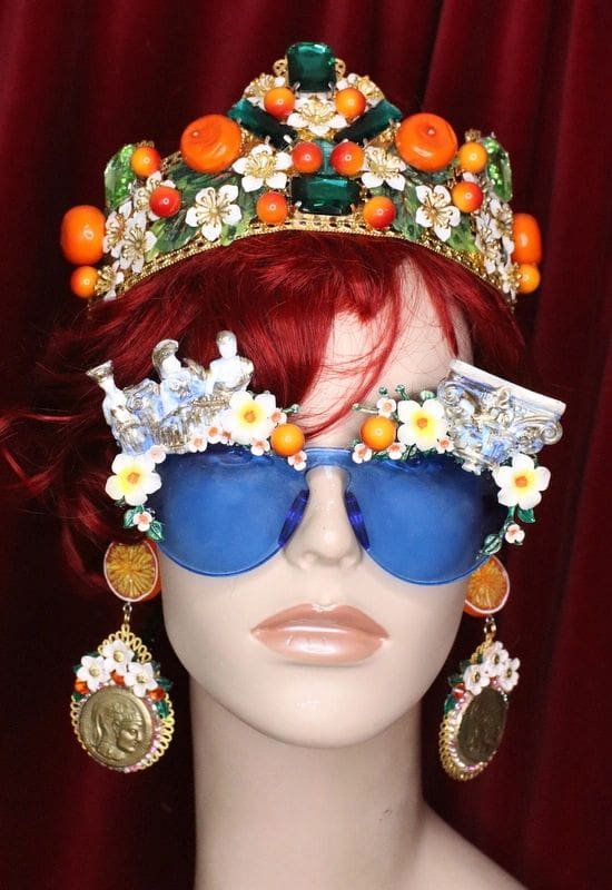 A mannequin wearing sunglasses and a crown.