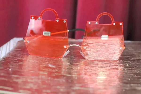 A table with two red bags and glasses on it