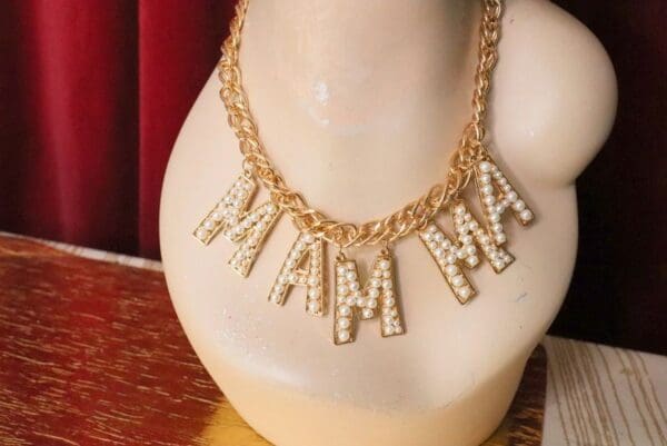 A necklace with the letters mama mia on it