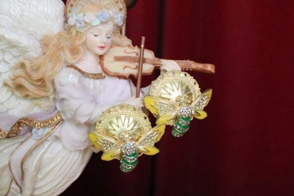 A close up of two christmas ornaments on top of a tree