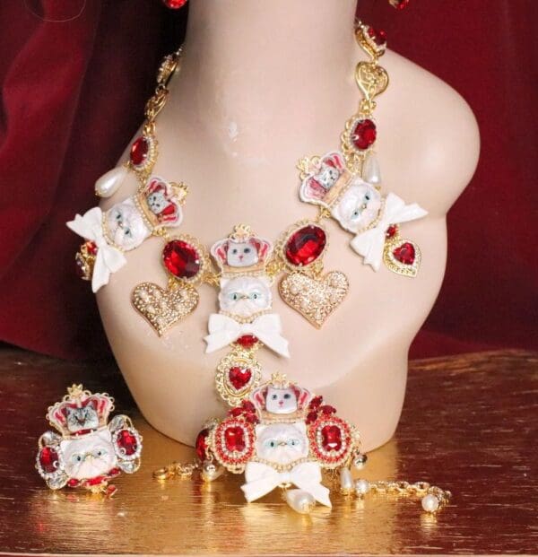 A necklace and earrings set with red stones.
