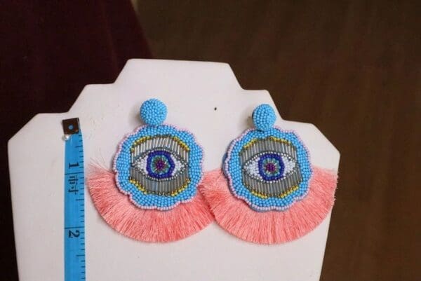 A pair of earrings with an eye on them.