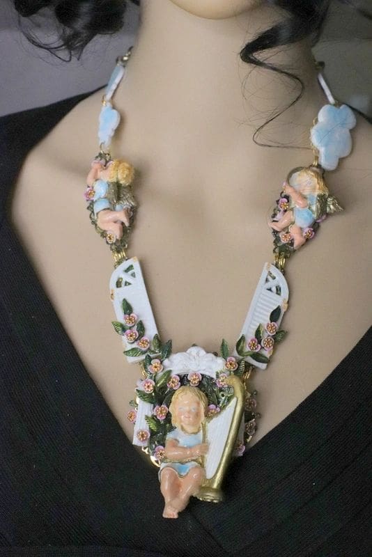 A woman wearing a necklace with some figurines on it