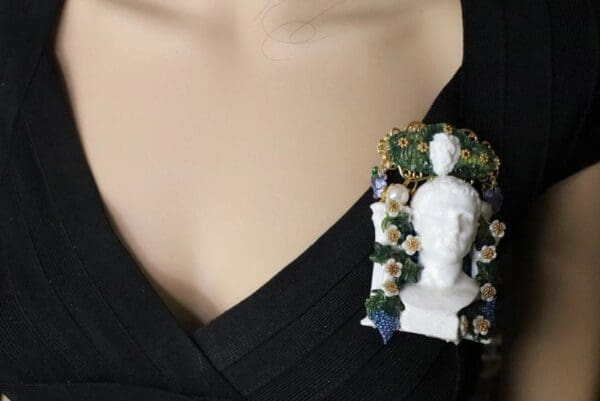 A woman wearing a black shirt with a white bust and flowers on it.