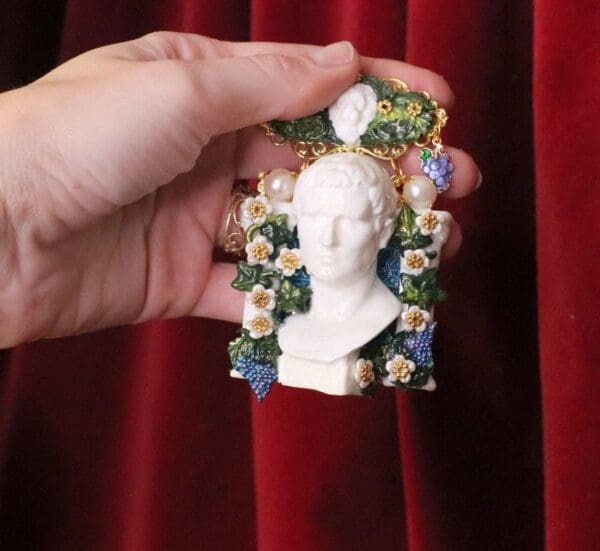A person holding onto a small statue of a woman