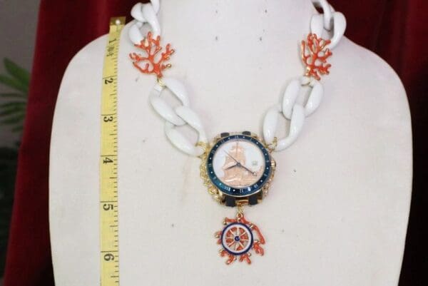 A necklace with a watch and a chain on it