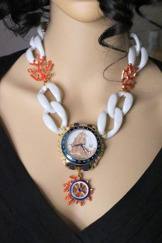 A woman wearing a necklace with a watch on it.