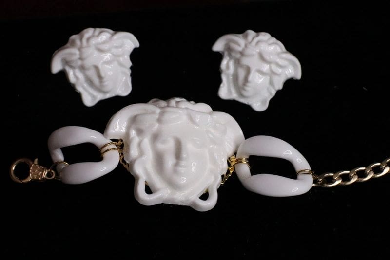 A white versace necklace and earrings set.