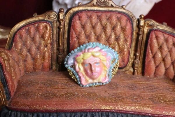 A close up of a doll 's chair with a face on it