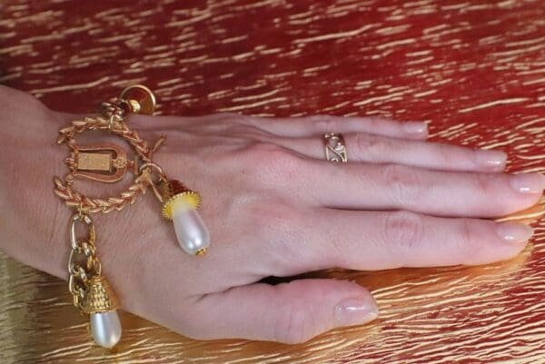 A hand with two rings and one gold ring on it