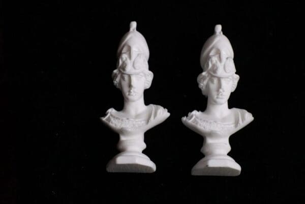 Two white statues of a man and woman.