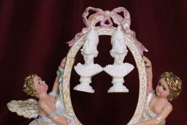 A picture of two angels holding vases in front of a mirror.