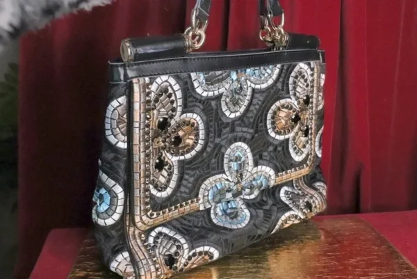 A purse with many different colored stones on it.