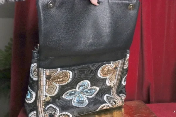 A close up of the front pocket on a purse
