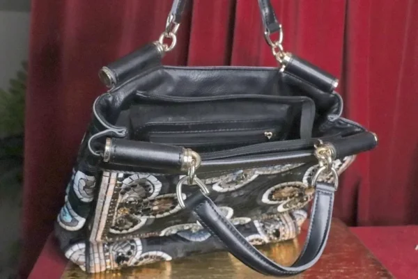 A purse that is sitting on the ground.