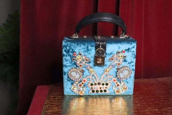 A blue purse sitting on top of a table.