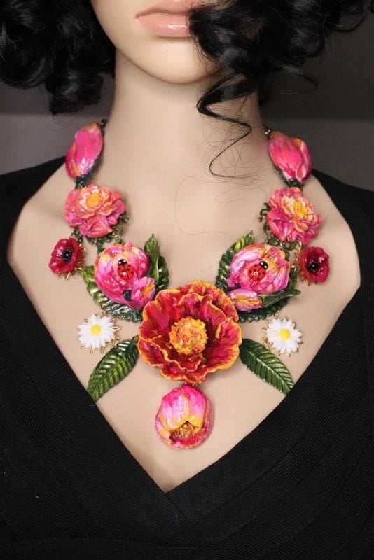 A woman wearing a necklace with flowers on it.