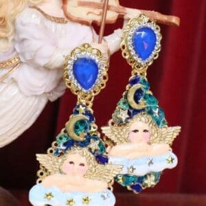 A pair of earrings with angels and blue stones.