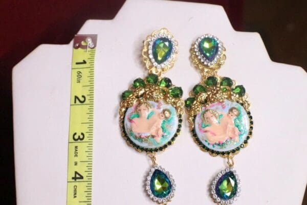 A pair of earrings with a picture on them