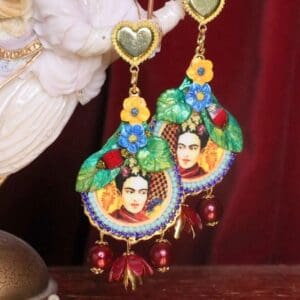 A pair of earrings with frida kahlo on them.