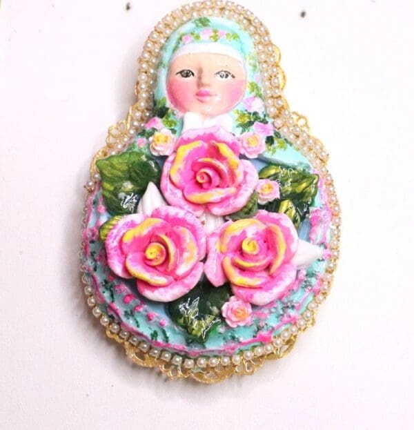 A doll with pink flowers on it's head.