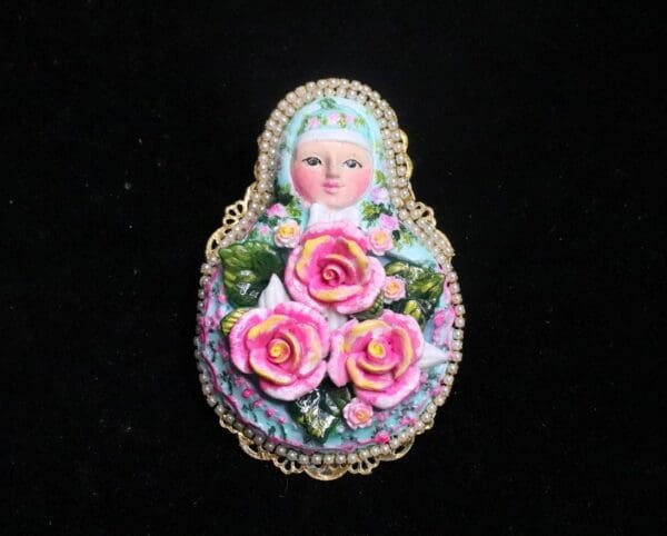 A doll with pink roses on it's head.
