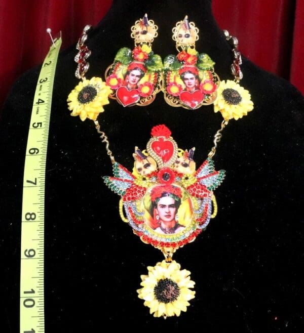 A necklace and earrings set with frida kahlo on it.