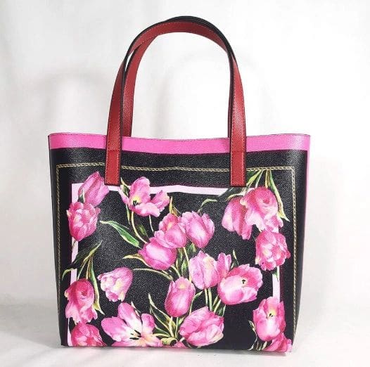 A black and pink floral bag with red handles.