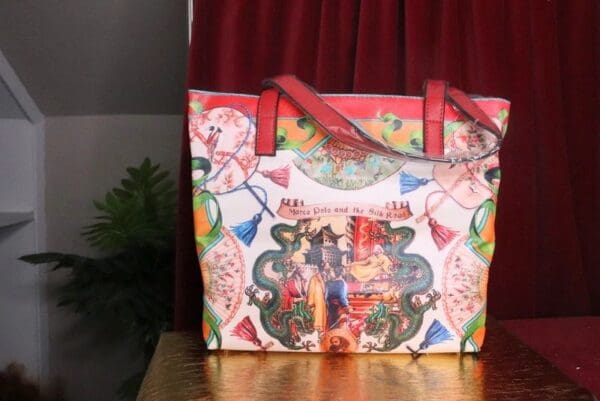 A bag with a picture of people and balloons on it.