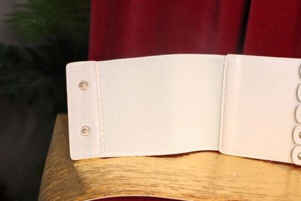 A white card board with two holes in it.