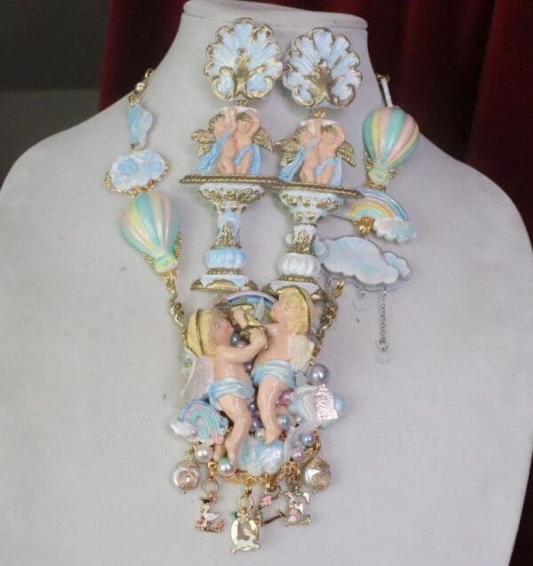 A necklace with angels and clouds on it