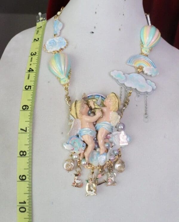 A necklace with a fairy and butterfly on it.