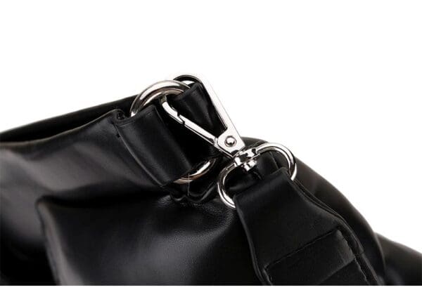 A close up of the strap on a black bag